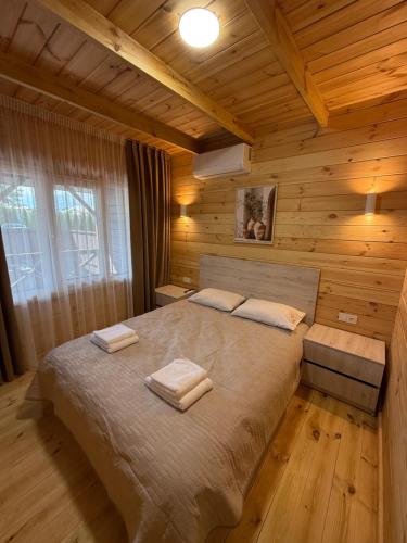a bedroom with a large bed in a wooden cabin at Hotel Voyage Вояж in Uman