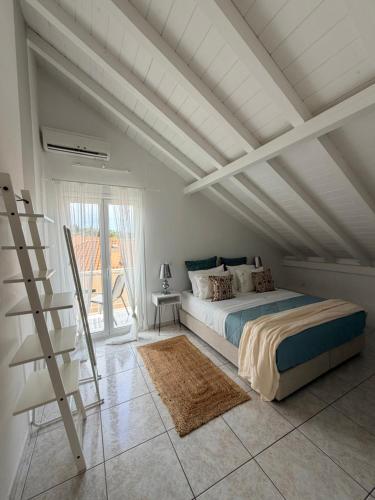 a bedroom with a bed and a white ceiling at Angel Apartment in Fiskardo
