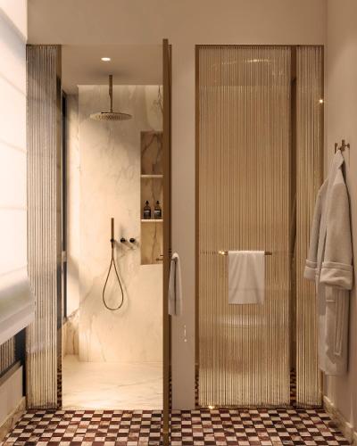 a shower with a glass door in a bathroom at Petra Hotel Belgrade in Belgrade