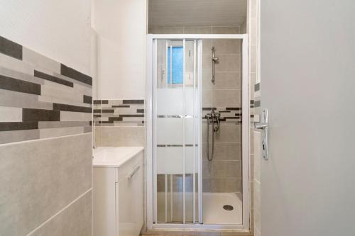 a bathroom with a shower and a sink at 15.La colline Clim.option- 6 pers in Calviac