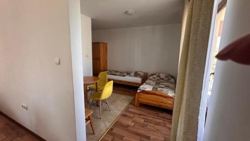 a small room with a bed and a table at Willa Agma in Zakopane