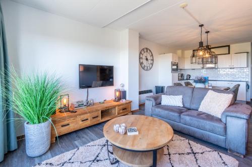a living room with a couch and a table at Appartementencomplex Juliana 94 in De Koog