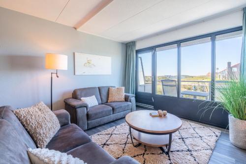 a living room with a couch and a table at Appartementencomplex Juliana 94 in De Koog