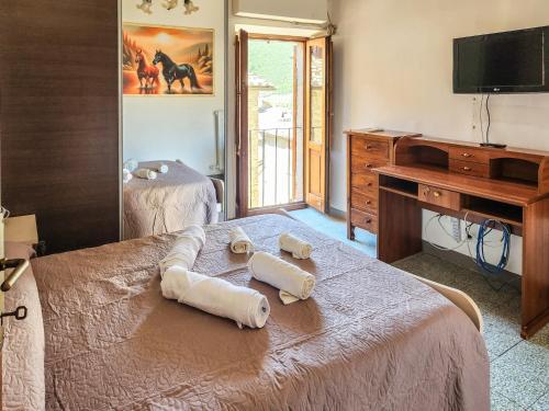 a bedroom with a bed with two towels on it at Il Chiostro di Ribot in Lugnano in Teverina