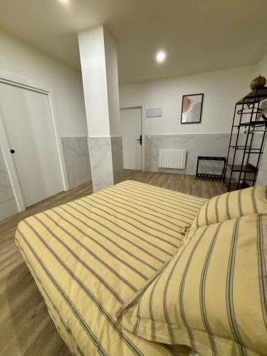 a large bed in a room with a ladder at URDAIHOME SUITES & BIKEs in Guernica y Luno