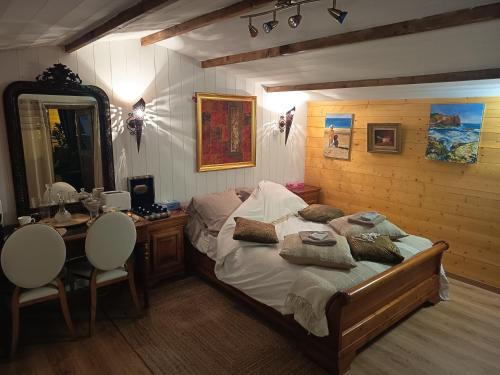 a bedroom with a bed and a desk and a mirror at Chalet Les Buis in Saint-Paul-lès-Romans