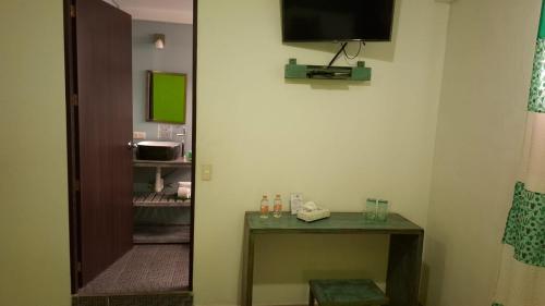 a room with a table and a television on the wall at Hotel Boutique Acocalli in San Juan Teotihuacán
