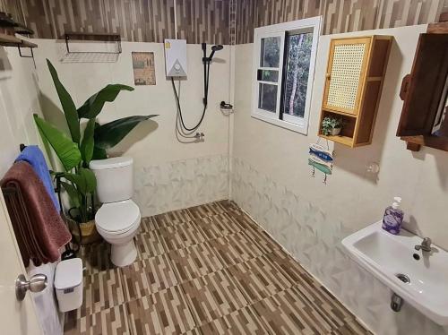 a bathroom with a toilet and a sink at Blue Cottage Koh Kood a Quiet Tropical Getaway in Ban Lak Uan