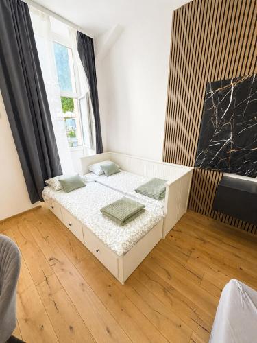 a bedroom with a bed in a room with a window at City Apartment 1 in Vienna