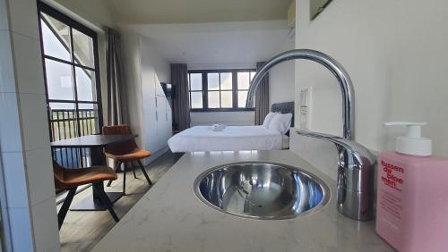a bathroom with a sink in the middle of a room at Sientjes Boetiekhotel in Kerkdriel