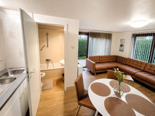 a living room with a table and a couch at Maxent aan zee in Middelkerke