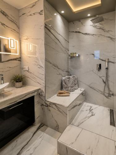 a white bathroom with a sink and a mirror at GF Luxury Villa with indoor pool -Afytos in Afitos