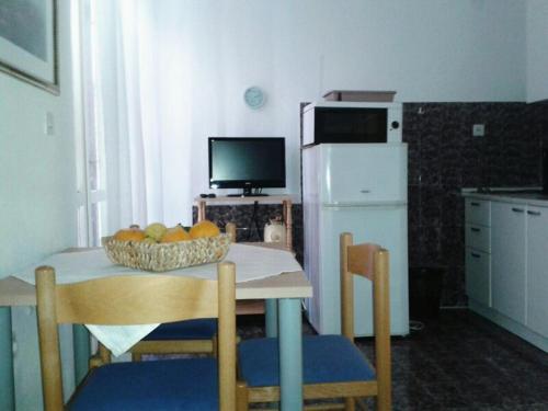 uma cozinha com uma mesa com uma taça de fruta em Apartments Marinana em Ražanj