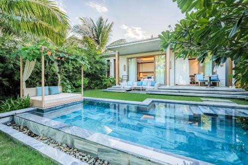 a swimming pool in the backyard of a house at Mia Quy Nhon in Quy Nhon