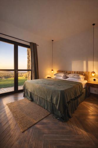 a bedroom with a bed and a large window at Casa Campo Longo in Belgodère
