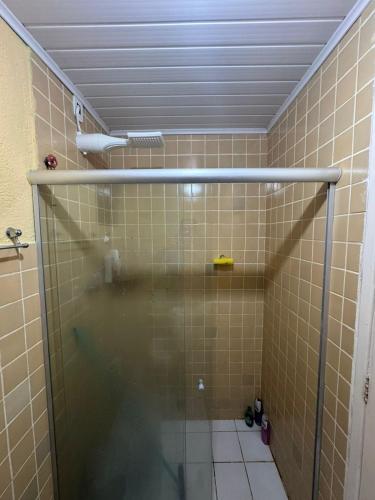 a shower with a glass door in a bathroom at Espaço rosa mar in Aracaju