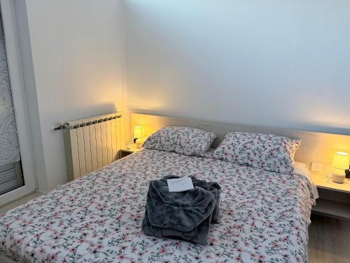 a bedroom with a bed with a backpack on it at Hugo s home, apartman blizu bazena i bolnice in Krapinske Toplice