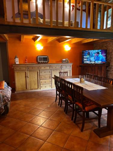 a kitchen with a table and chairs and a tv at Chalet Calcar in Avenone