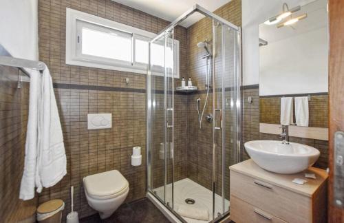 a bathroom with a shower and a toilet and a sink at Kanavayen Tres in Santanyi