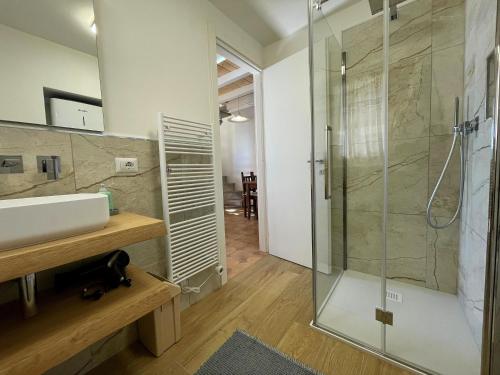a bathroom with a sink and a glass shower at Casa Caprice in Cannero Riviera