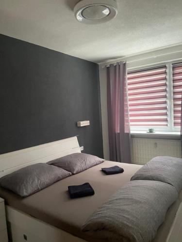 a bedroom with a bed with two towels on it at Slnečný byt pri lesoparku in Prievidza