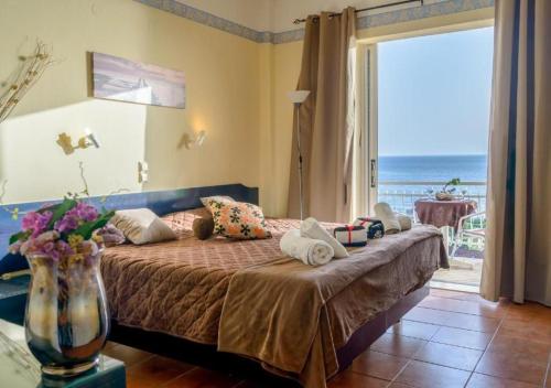 a bedroom with a bed with a view of the ocean at Beach Oasis by BS- in Agios Gordios