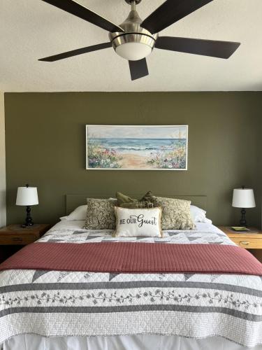 a bedroom with a bed with a ceiling fan at Baypoint Condo, Pool, Dock, relaxing location in Lake Ozark