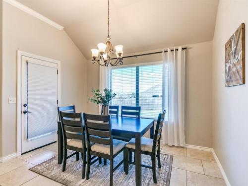 a dining room with a blue table and chairs at Where Comfort Meets Luxury in Yukon