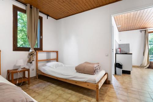 a bedroom with a bed and a large window at 10. cerisiers option clim- 4 pers in Calviac
