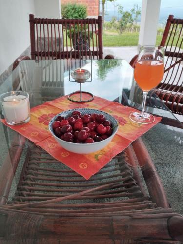 a bowl of fruit sitting on a table with a drink at Casa Rotti - Countryside Retreat near Krško in Krško