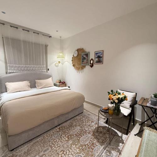 a bedroom with a bed and a table and a chair at Bali island Studio in Al Khobar