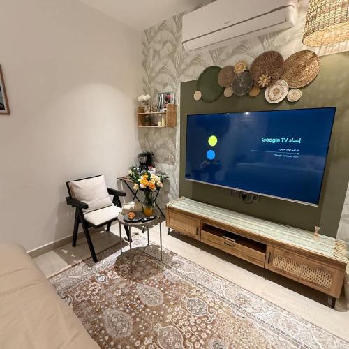 a living room with a large flat screen tv at Bali island Studio in Al Khobar