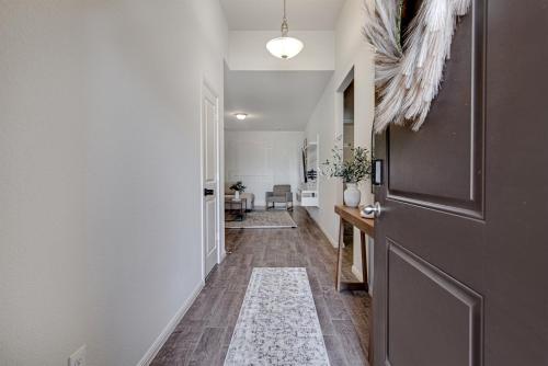 a hallway with a door with a rug on the floor at A Serene Oasis! 4-bedrooms! in Saginaw