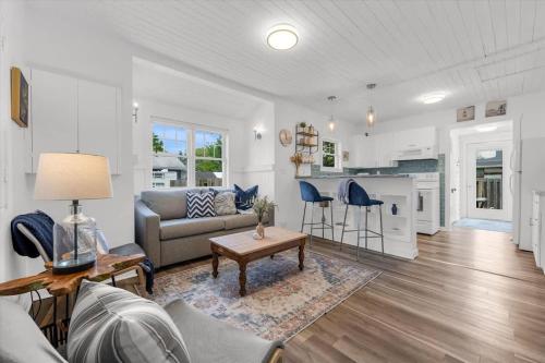 a living room with a couch and a table at Fall Getaway|Crystal Beach Passes|Hottub|FirePit in Fort Erie