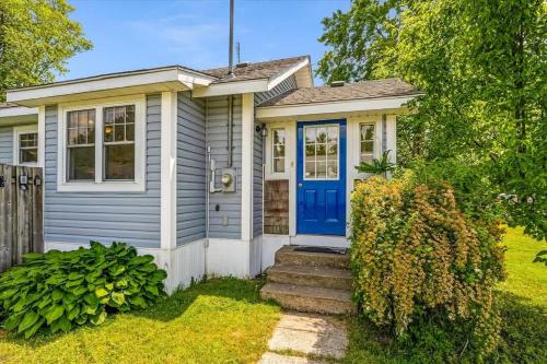 a small house with a blue door at Fall Getaway|Crystal Beach Passes|Hottub|FirePit in Fort Erie