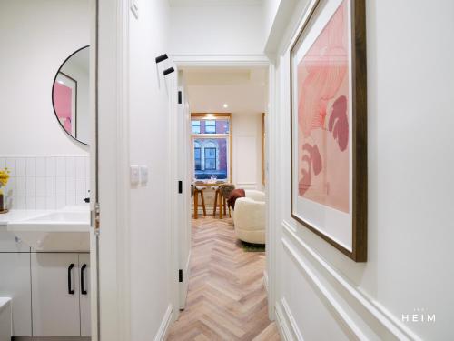 a kitchen with a hallway with a sink and a mirror at The Heim Aparthotel in Manchester