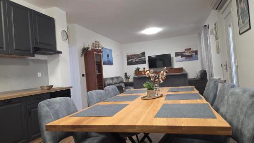 a dining room with a wooden table and chairs at Krka Hideaway in Lozovac
