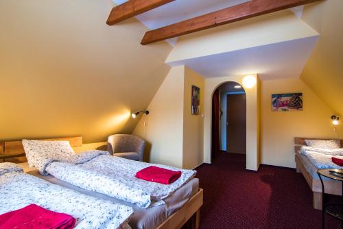 a hotel room with two beds and a hallway at Penzion Slunečnice in Rokytnice nad Jizerou