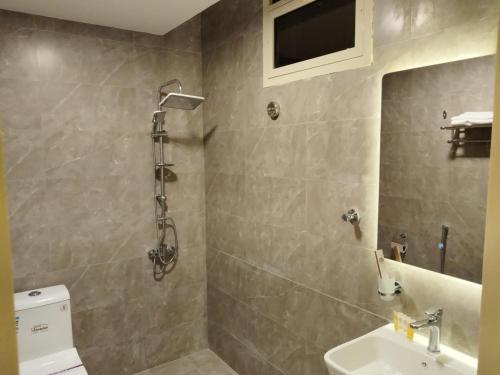 a bathroom with a shower and a toilet and a sink at أصالة الشروق حائل in Hail