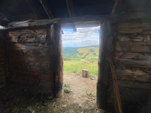 an open door of a log cabin with a view at Osada Słowiańska in Chyrowa