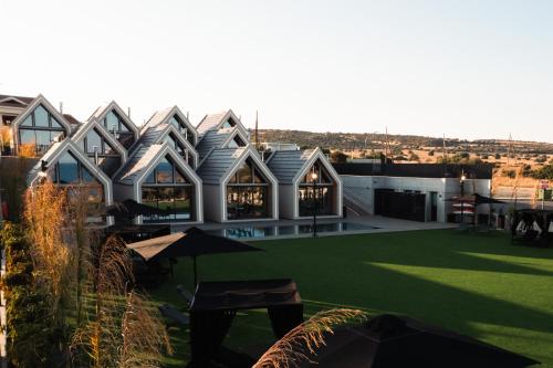 a building with a green lawn in front of it at NOE Suites in Ayios Theodhoros
