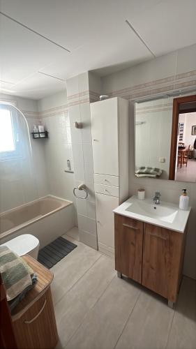 a bathroom with a sink and a bath tub at Front beach apartment in Torreblanca