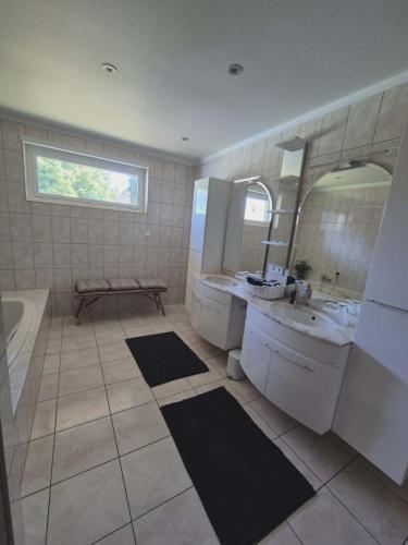 a bathroom with a sink and a toilet and a mirror at Villa La Digue in Plobsheim