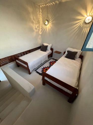 two beds sitting in a room with at Villa Zina s3 in El Mây