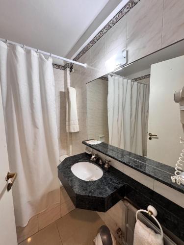 a bathroom with a sink and a mirror at Gran Hotel Buenos Aires in Buenos Aires