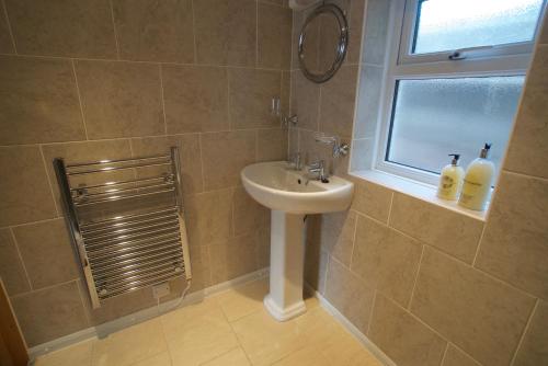 a bathroom with a sink and a window at Chynoweth Mews in Newquay
