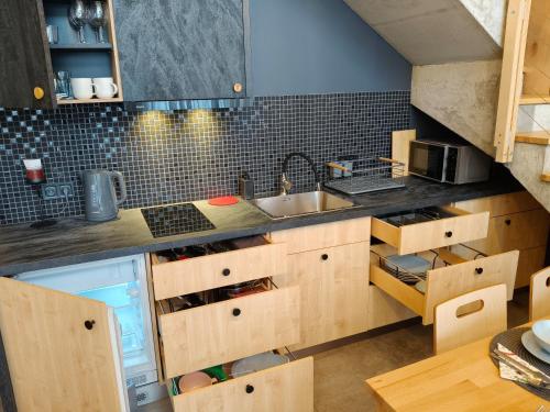 a kitchen with wooden cabinets and a sink at Harasiuki House in Harasiuki