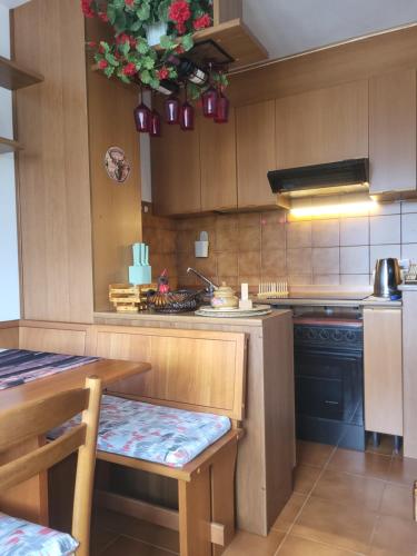 a kitchen with wooden cabinets and a table and a table and a table sidx sidx at Casa Bella Vista in Foppolo