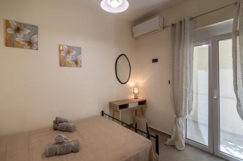 a bedroom with a bed and a window at Stellasrooms in Mytilene