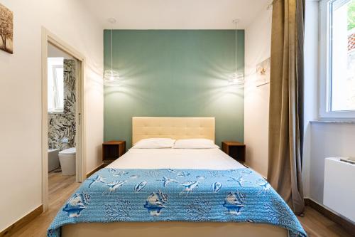 a bedroom with a bed and a window at Aroma Rooms Procida in Procida
